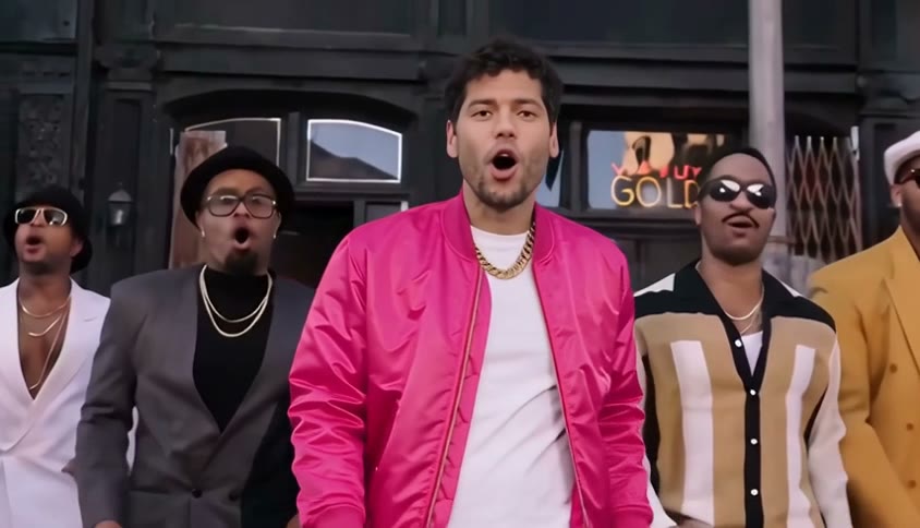 Beat 1 of an Uptown Funk AI video: a man in a pink bomber jacket struts towards the camera at the front of the crew
